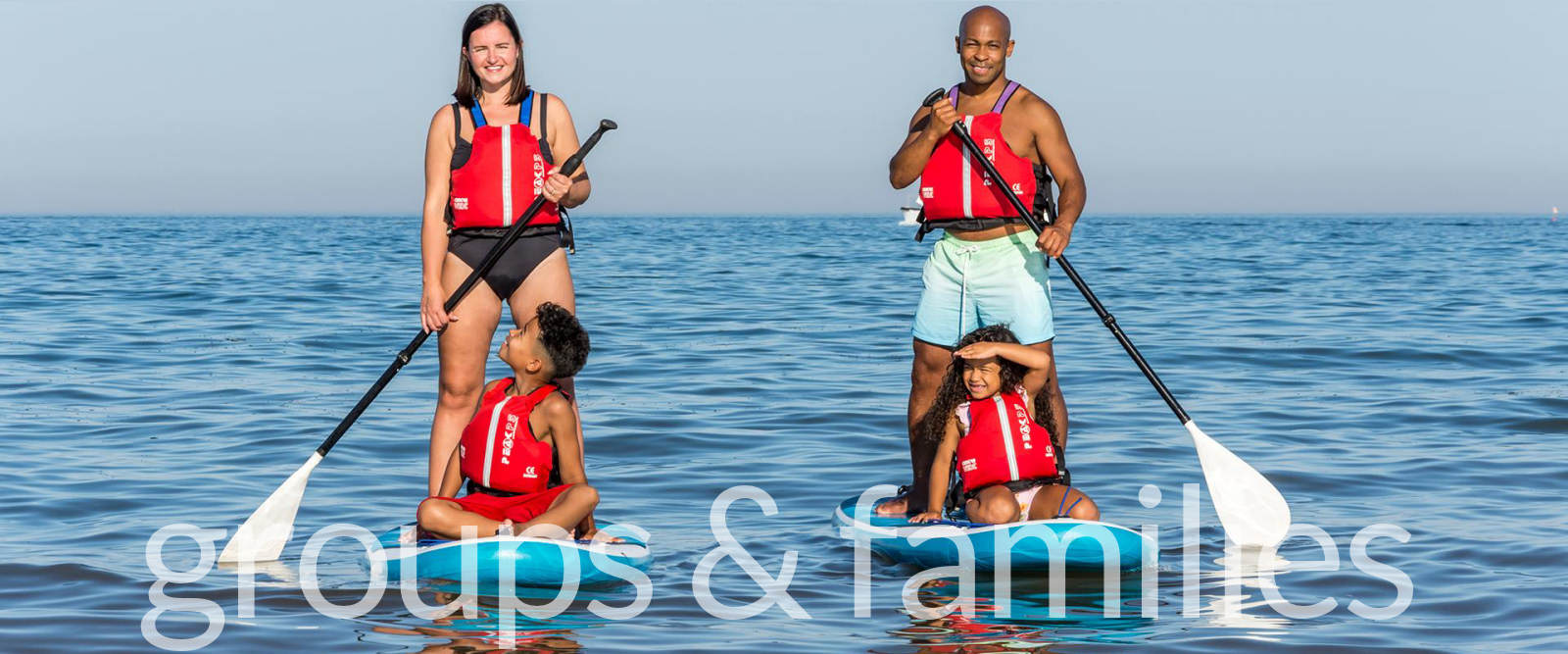 A family paddleboarding at Nolton Haven, Pembrokeshire